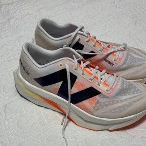 New Balance White and Orange carbon plate Fuel Cell Elite
